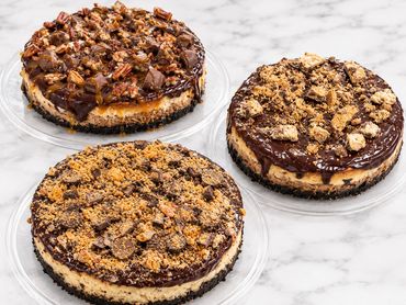 Three cheesecakes with chocolate and nuts toppings.
