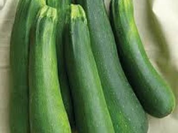Fresh green zucchinis grouped together.
