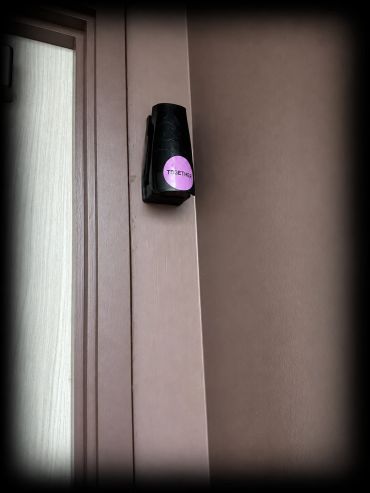 Black dispenser containing Ethicork™ mounted beside the door in a TOGETHER.SPACE accessible washroom