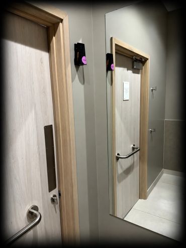 Dispenser containing Ethicork™ mounted between a wood door and mirror in a TOGETHER.SPACE washroom