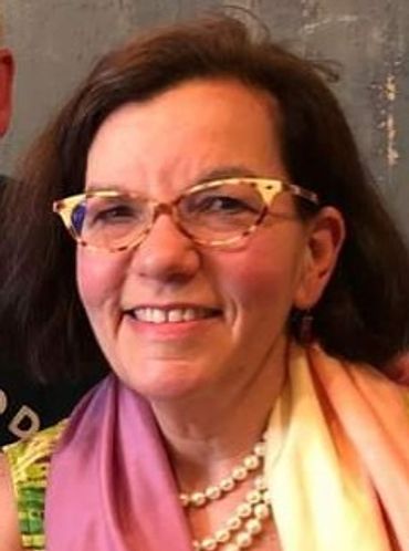 Elizabeth Feinberg. A  mid-aged white woman with glasses and dark hair smiles.