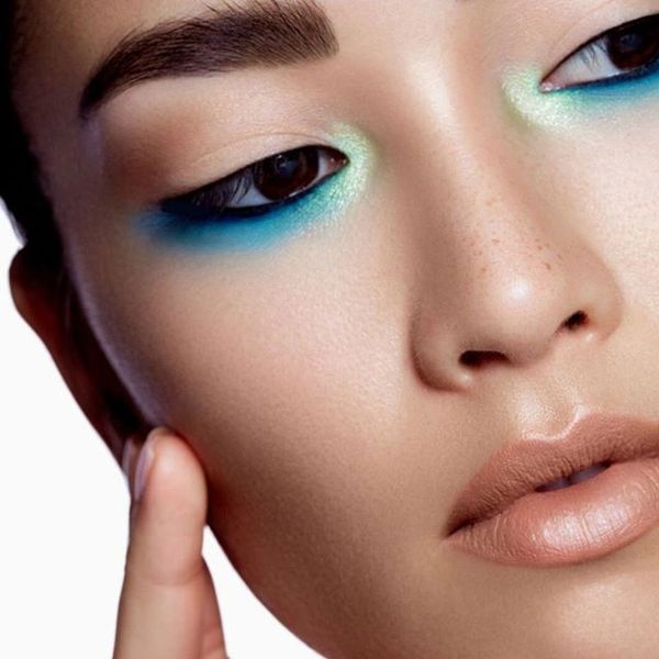 blue eye shadow under eyes on female Asian model