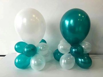 Teal and white balloon centerpieces arranged in clusters.