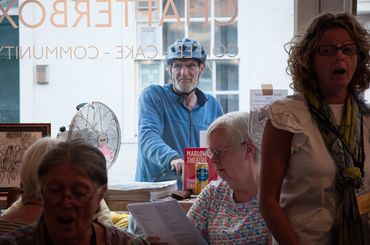 Cyclist stops to have a look (and a listen) to Jubilate Choir, singing for their supper.