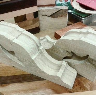 Intricately carved wooden pieces with elegant curves and details.
