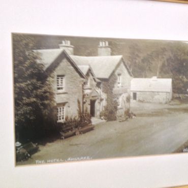 A vintage photo of The Hotel, Ambleside, showing a stone building with chimneys.