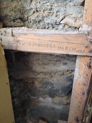 Old wooden beam with handwritten inscription from 1933.