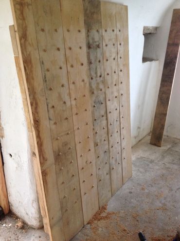 Large wooden board with multiple wooden pegs arranged in rows.