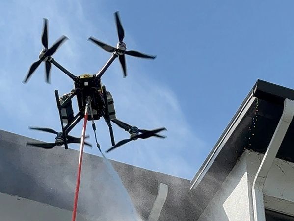 Drone Cleaning Services cleaning facade and roof of the building FlyWash Drone