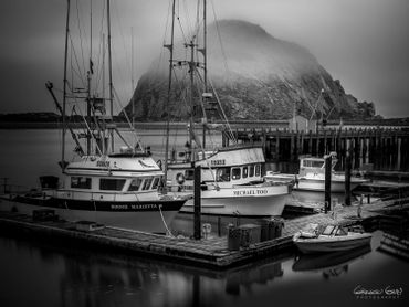 Black and white photograph of fishing boats at Morro Bay docks.