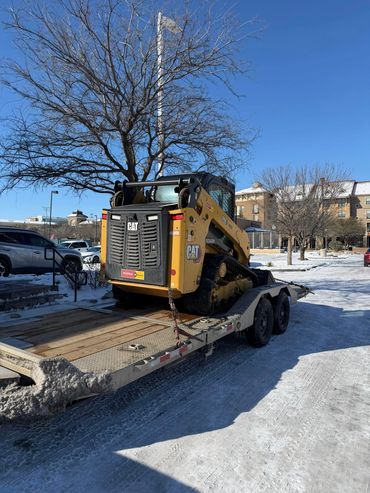 Skid steer loaded onto Iron Bull tilt equipment trailer rental in Lubbock TX