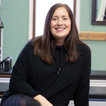 Rebecca Anderson smiling at the camera at Thrive Pilates.