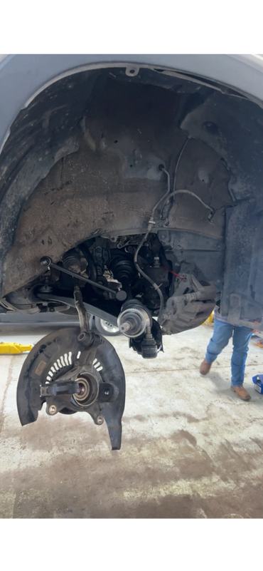 Car wheel hub and suspension system exposed without the tire.