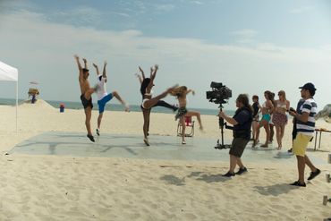 Dancers performing on the beach to "I Wish I was Sag: DP Ben Wolf follows them with his camera. 