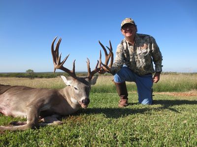 This is an image of a hunter and harvested trophy buck on the Hindes Ranch in south Texas.