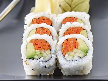 Close-up of sushi rolls with avocado and carrot.