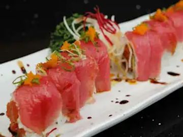 Fresh tuna sushi rolls on a white plate.