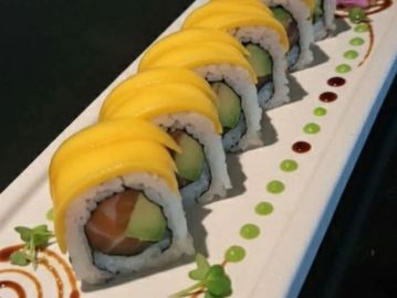 Sushi rolls topped with mango slices.