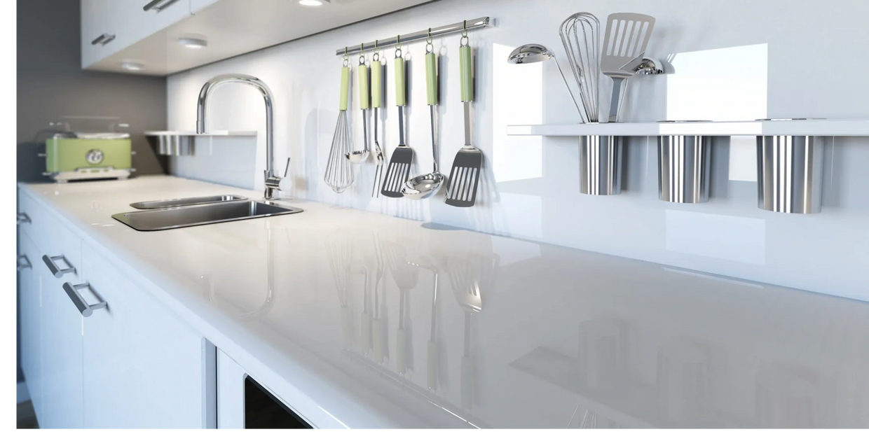 Sleek modern kitchen with hanging utensils and a shiny countertop.