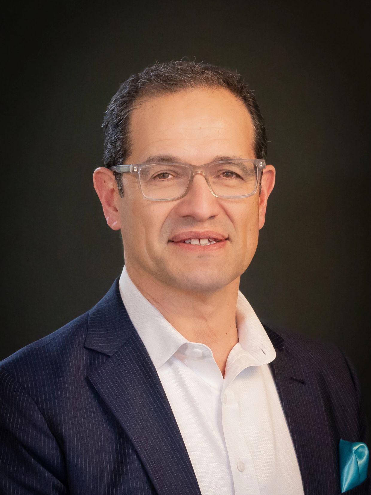 Professional man in glasses wearing a suit and white shirt.