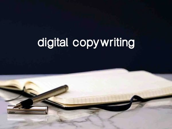 A notebook lies open on a marble top with a fountain pen ready to write with the cap off on top