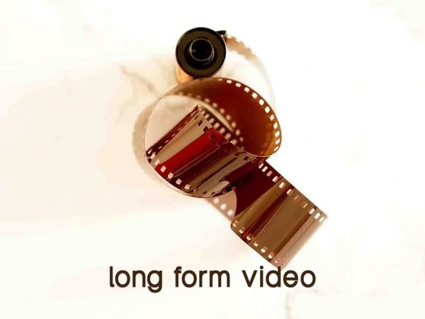 A reel of film curls on a marble top
