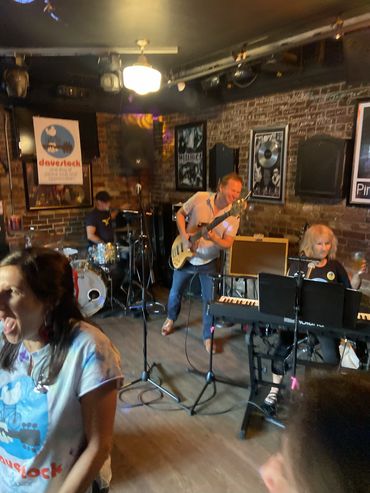 Live band playing in a cozy pub with lively audience members.