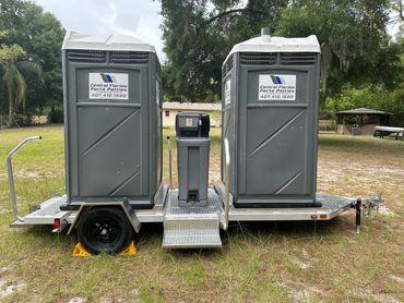 Dual porta potty trailer with steps and a handwashing station