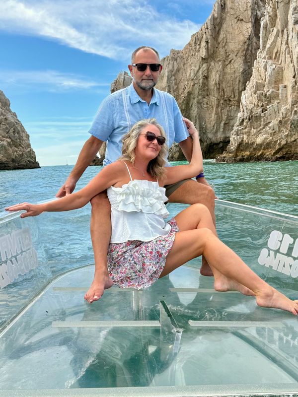 Couple enjoying a boat ride with scenic rock formations.