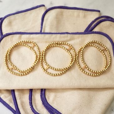 Three relationship status bracelets laying on flannel cloths.