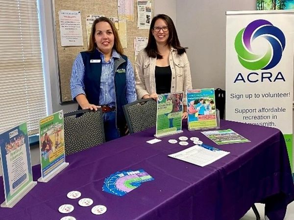 ACRA team members at a display table