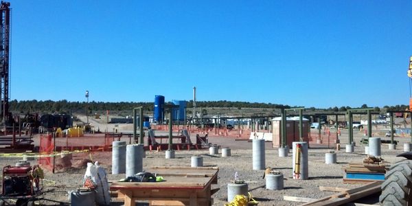 Industrial construction site with concrete pillars and equipment.