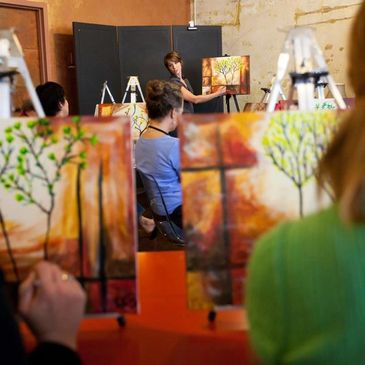 People painting trees during an art class session.