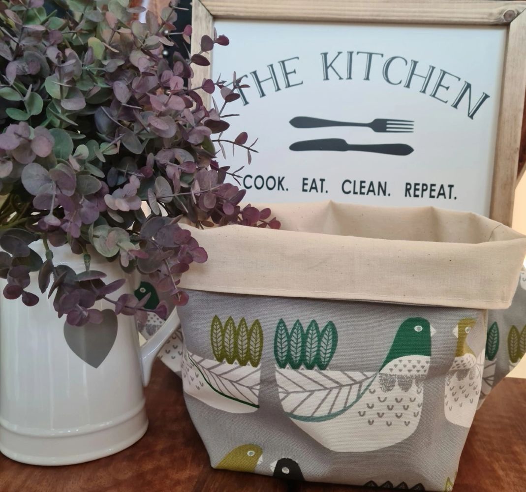 Kitchen Sign with fabric basket and white jug filled with purple tip eucalptus.