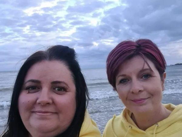Two ladies standing on a beach. Caroline & Mel the owners of Stanley & Lottie Ltd