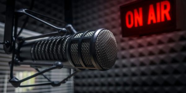 Professional microphone in the studio of the radio station and on the air sign