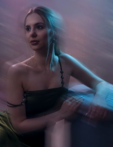 Elegant woman in a soft, dreamy light with a calm expression.