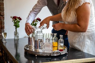 Bride and groom mix a wedding cocktail, during wedding celebrant ceremony in Bristol.