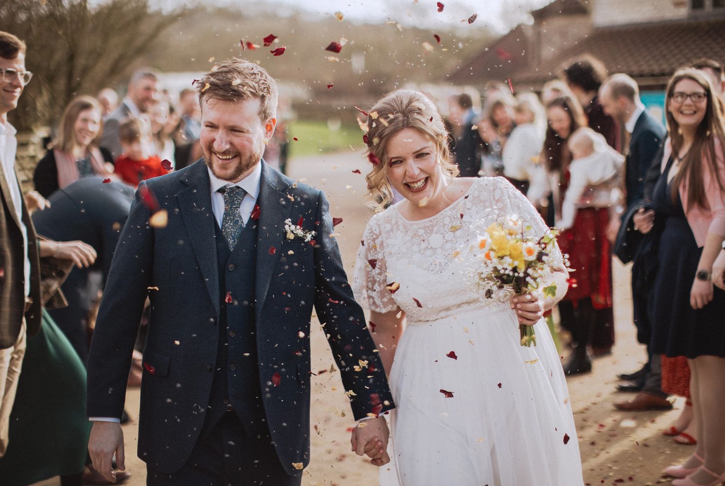 Bride and groom, outdoors with confetti