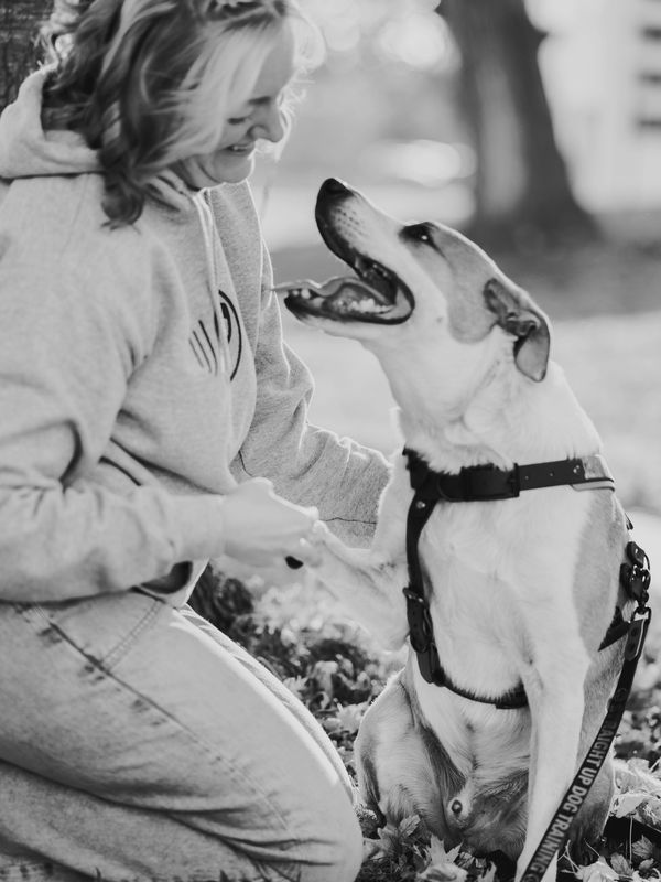 Emily and her dog Fitz smiling together—preparing to take their podcast and training on the road.