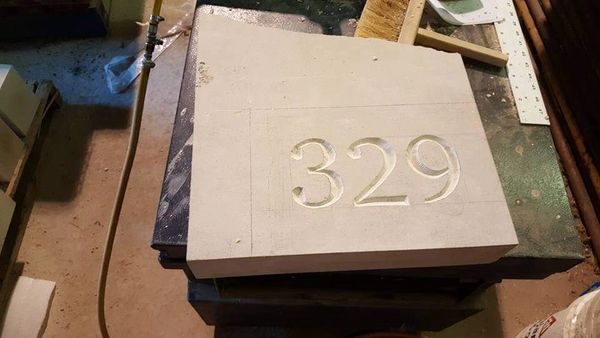 Natural Stone House Number in production being carved by one of our banker masons at our Hamilton Wo