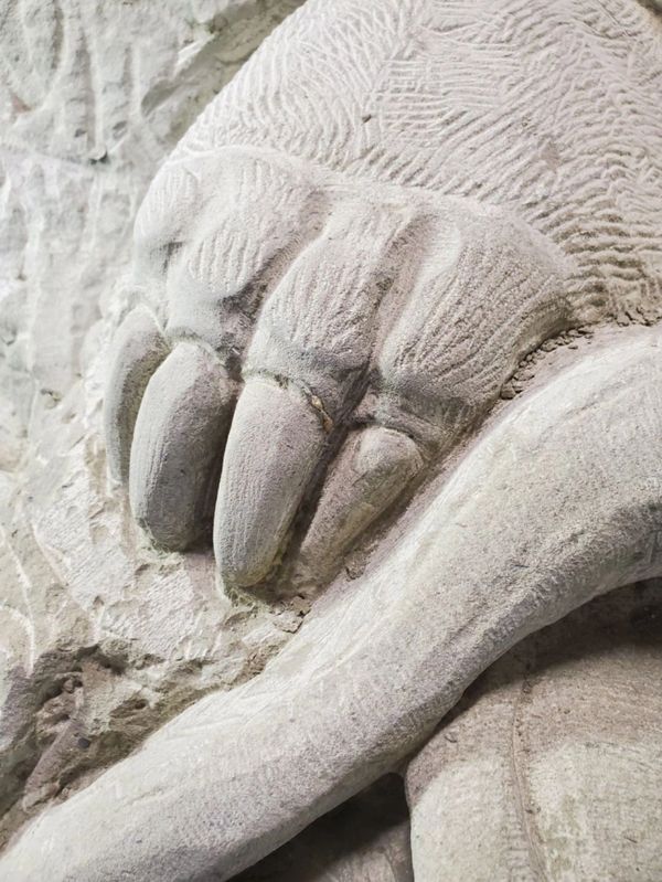 Intricate hand carved bear claw for elaborate stone wilderness fireplace