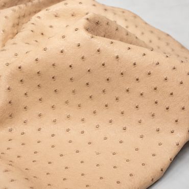 sandy ostrich leather with detailed texture.