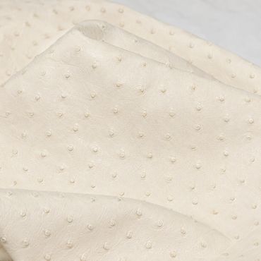 Pearly white ostrich leather with detailed texture.