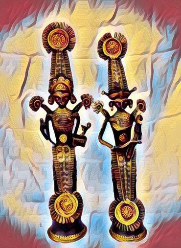 Two intricately designed tribal statues with tall headdresses and detailed patterns.