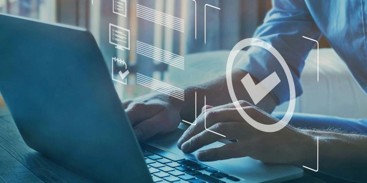 Person working on laptop with checkmark icons.