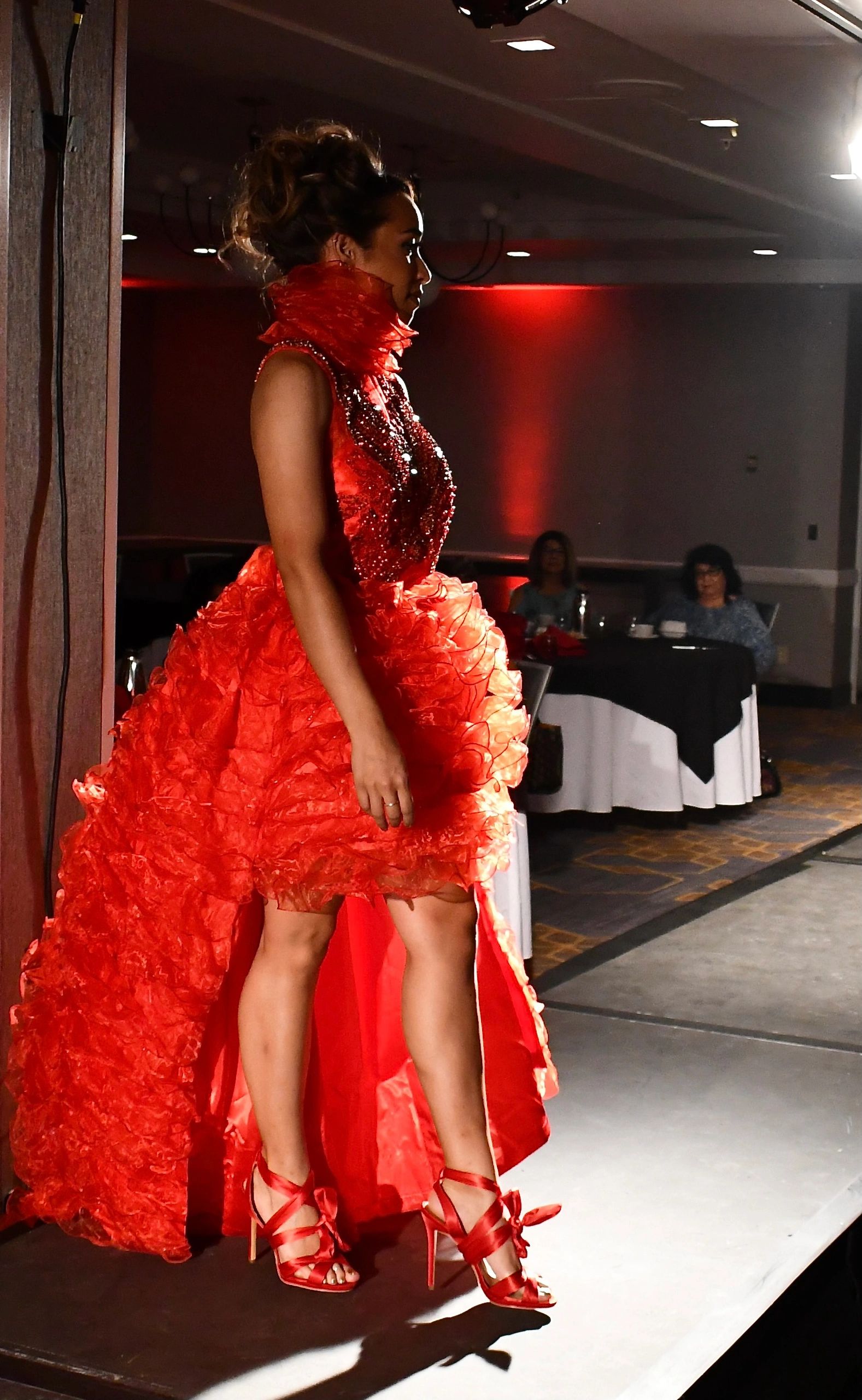 Red ruffled organza gown with heavy rhinestone bodice on silk in charmeuse lining.