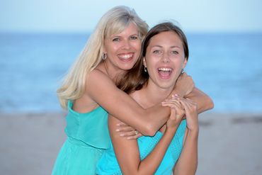 Beach Portrait By Paul Dimarco Photography of Mother and Daughter hugging and laughing on the beach.