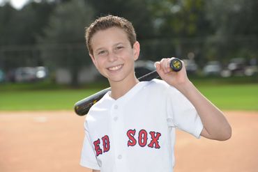 Senior Portrait By Paul Dimarco Photography of Teen Boy in his baseball uniform holding a bat.