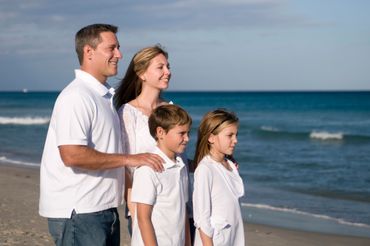 Beach Portrait By Paul Dimarco Photography of family  looking out at sea on the beach. 